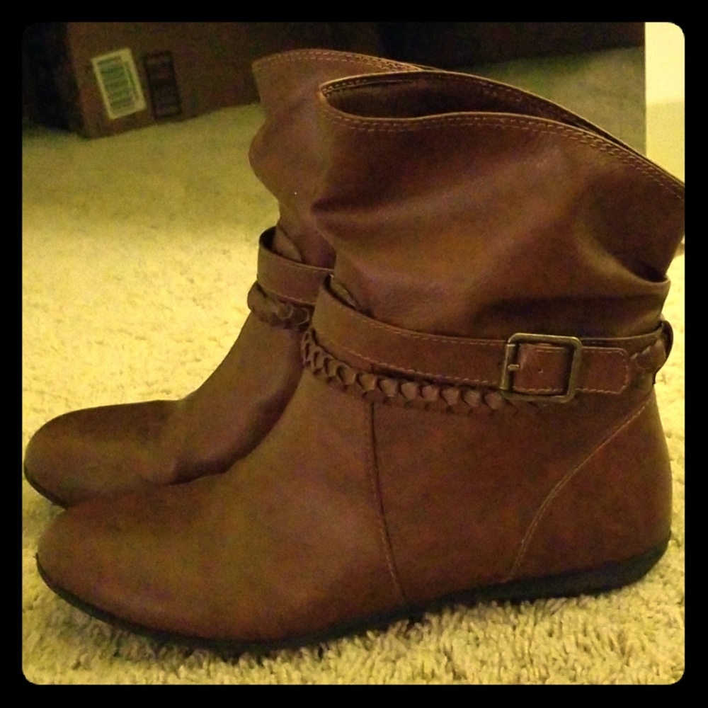 Cognac short ankle booties with strap accents.